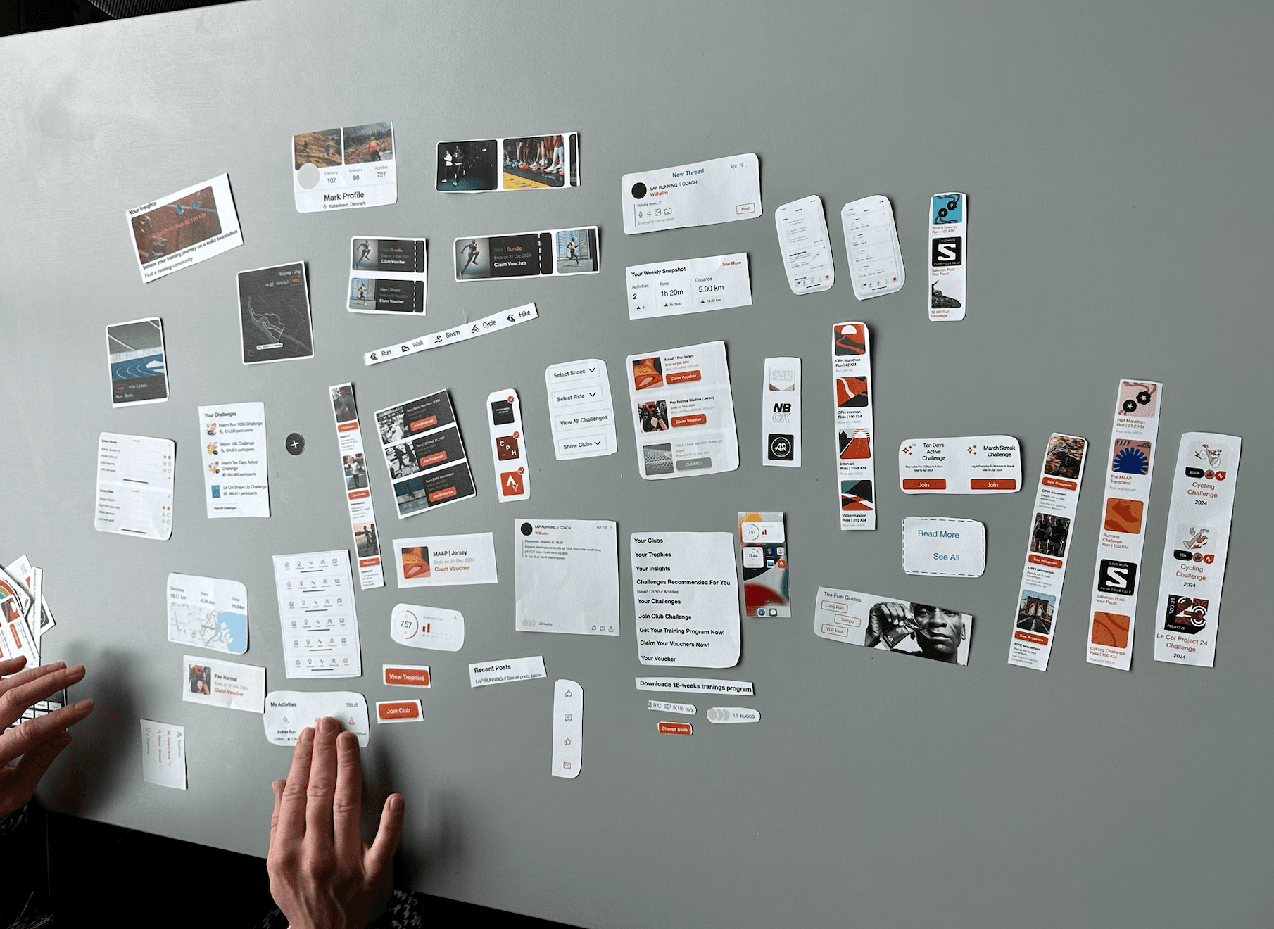 Co-design workshop: printed app screens laid out and rearranged on a table